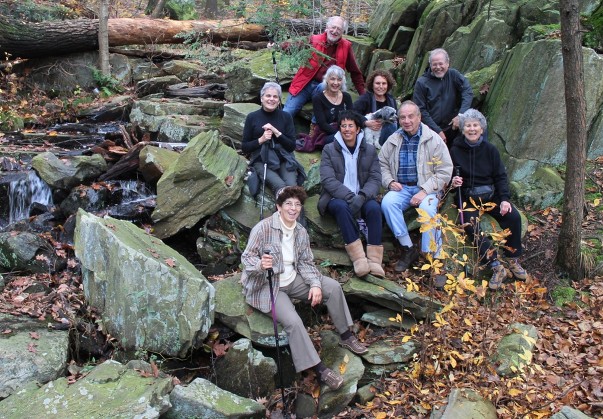 Suri posing with a group of people on a nature trail